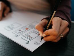 A woman drawing a mobile app wireframes